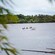 A group of people riding on a long boat along the shores of Suva, Fiji